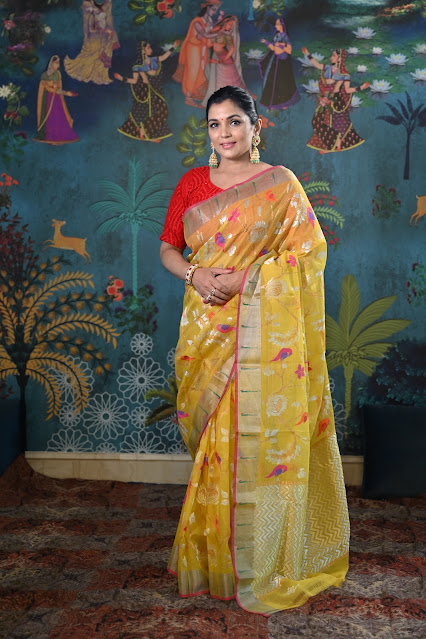 Sunshine yellow Kota doria with multicolour birds, lotus and muniya border.