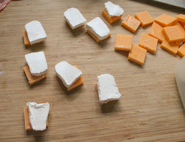 Slicing the cream cheese for making spicy marinated cheese.