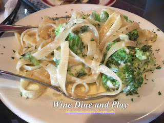 A simple dish of early bird fettuccini alfredo with broccoli at the Gigi's restaurant in St Pete Beach, Florida