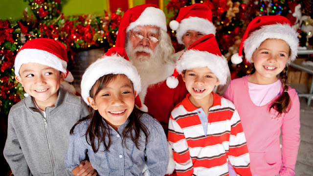 Santa with smiling children in Santa hats
