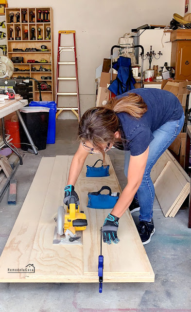 Cristina Garay using Dewalt circular saw and straight edge to cut ply doors