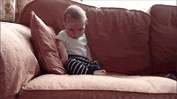 Gif of baby sitting on couch and tipping forward as they fall asleep