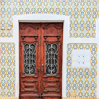 Wooden door surrounded by Portuguese tiles in Portimao in the Algarve