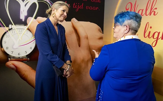 Queen Maxima wore a royal blue silk dress, and a blue wool cahmre cape by Natan. Sergio Rossi blue suede boots
