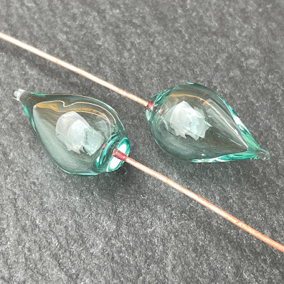 Handmade hollow lampwork glass headpins on copper wire by Laura Sparling