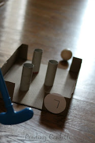 A nine hole miniature golf course made from cardboard boxes. A great way to keep kids entertained while they're stuck inside and a fun way to learn about physics.