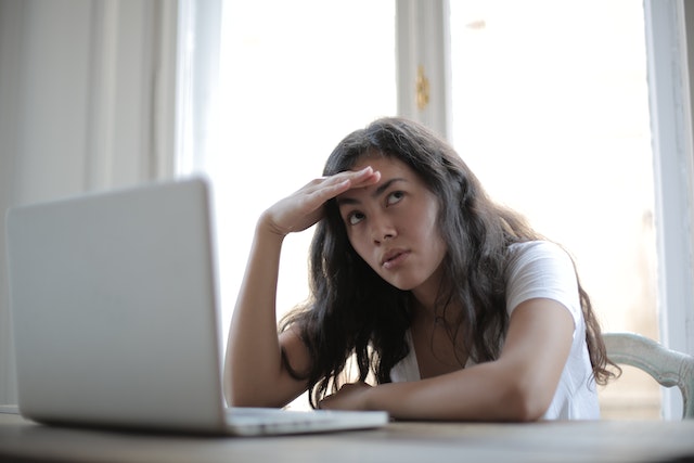 Woman looking away from the computer