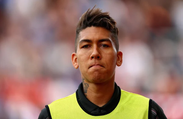 Roberto Firmino of Liverpool starts on the substitutes bench during the Barclays Premier League match between Stoke City and Liverpool at Britannia Stadium on August 9, 2015 in Stoke on Trent, England