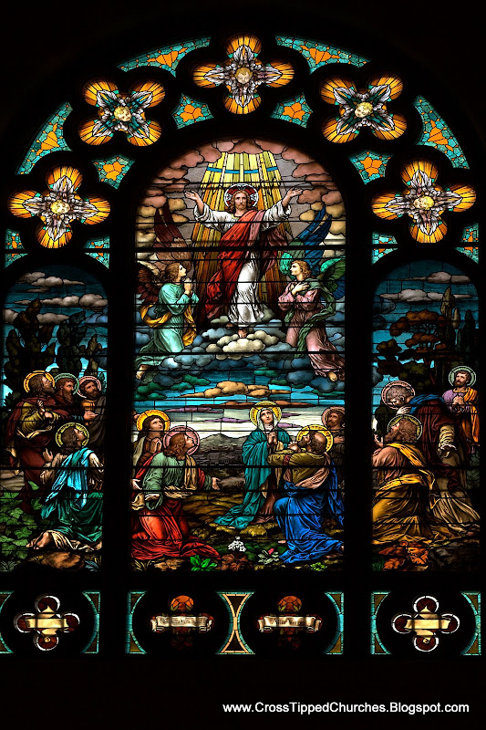 Large stained glass window of the resurrected Christ in the clouds with angels,and the deciples and Mary below.