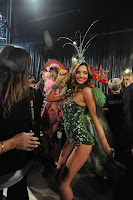 Miranda Kerr posing for cameras in a skimpy green outfit