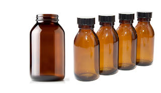 Why are medicine and chemicals kept in amber colored glass bottle?