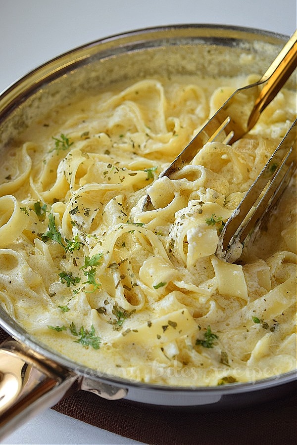 a close up of a pan with fettuccine alfredo