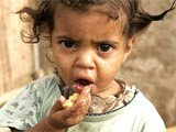 An AIDS orphan eats from a plate of food at a kindergarten in Manzini, Swaziland. 