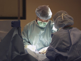 Surgeon with headlamp