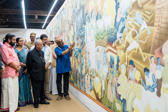 Artist P K Sadanandan Master explaining his mural work 'Parayi Petta Panthiru Kulam' to President Pranab Mukkherjee at Aspinwall House.  Minister for Tourism Kadakampally Surendran, Kochi Corporation Mayor Saumini Jain and Kochi Biennale 2016 curator Sudarshan Shetty are seen along.