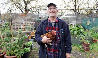 a man holding a chicken