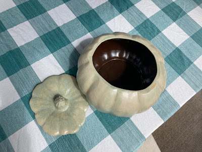 A ceramic ware pumpkin cassarole dish, with it's lid off.