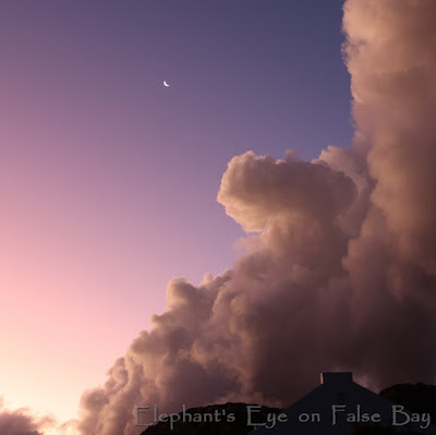 Sunset with towering clouds and moon