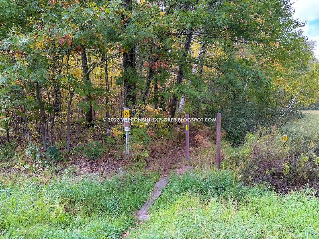 trail signs beside highway