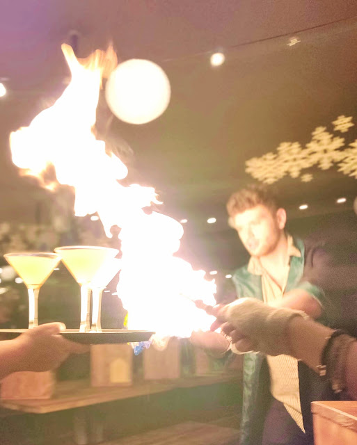 fiery cocktails and girl posting wand at The Cauldron, London