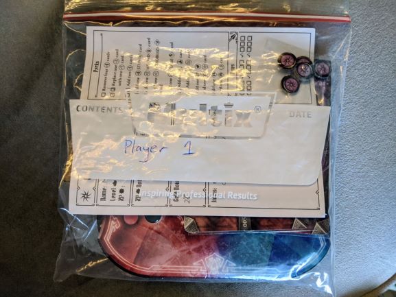 sandwich bag filled with gloomhaven player components