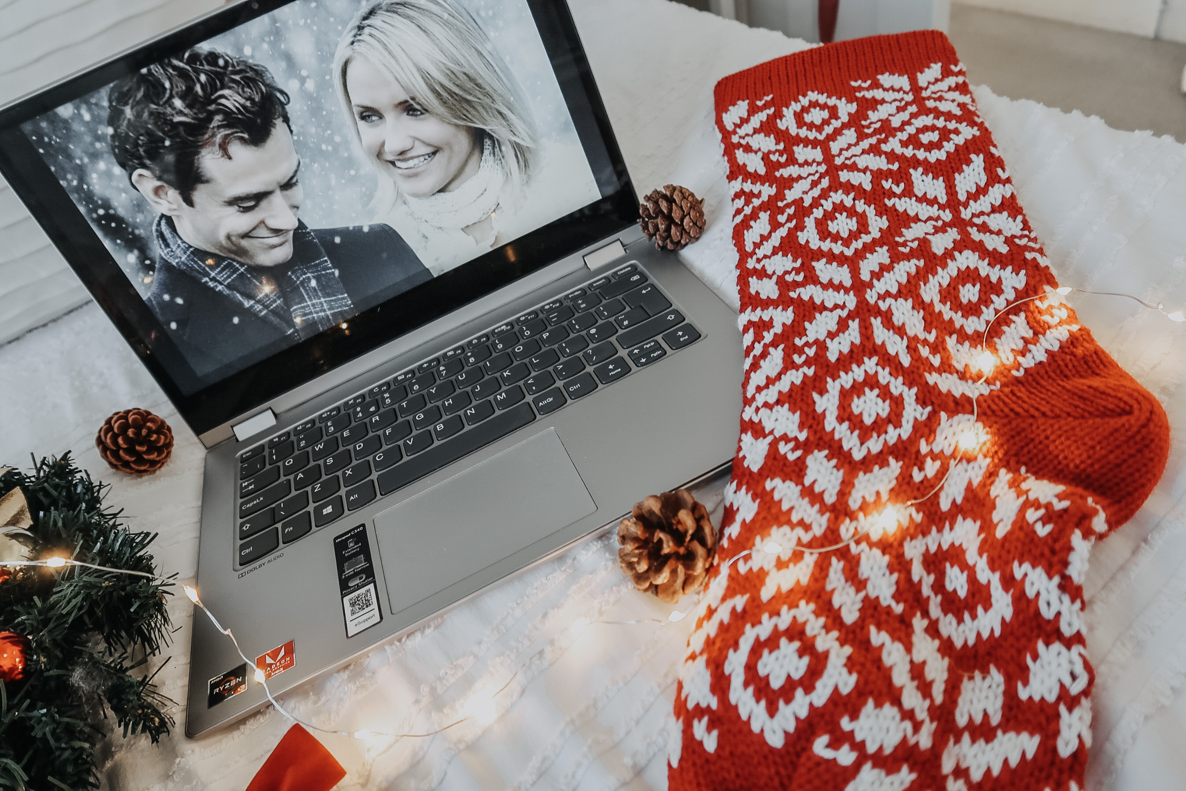 A laptop with the movie 'The Holiday' on screen.