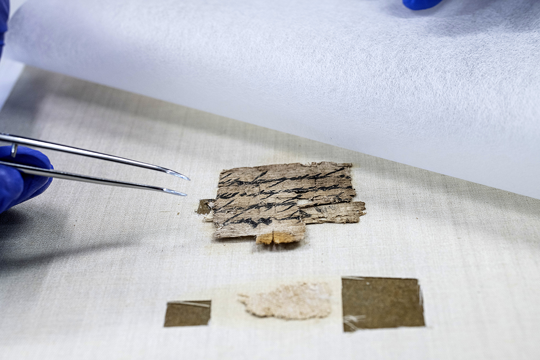 The papyrus is treated in the Scrolls Laboratory of the Antiquities Authority. Photo by Yuli Schwartz, Antiquities Authority