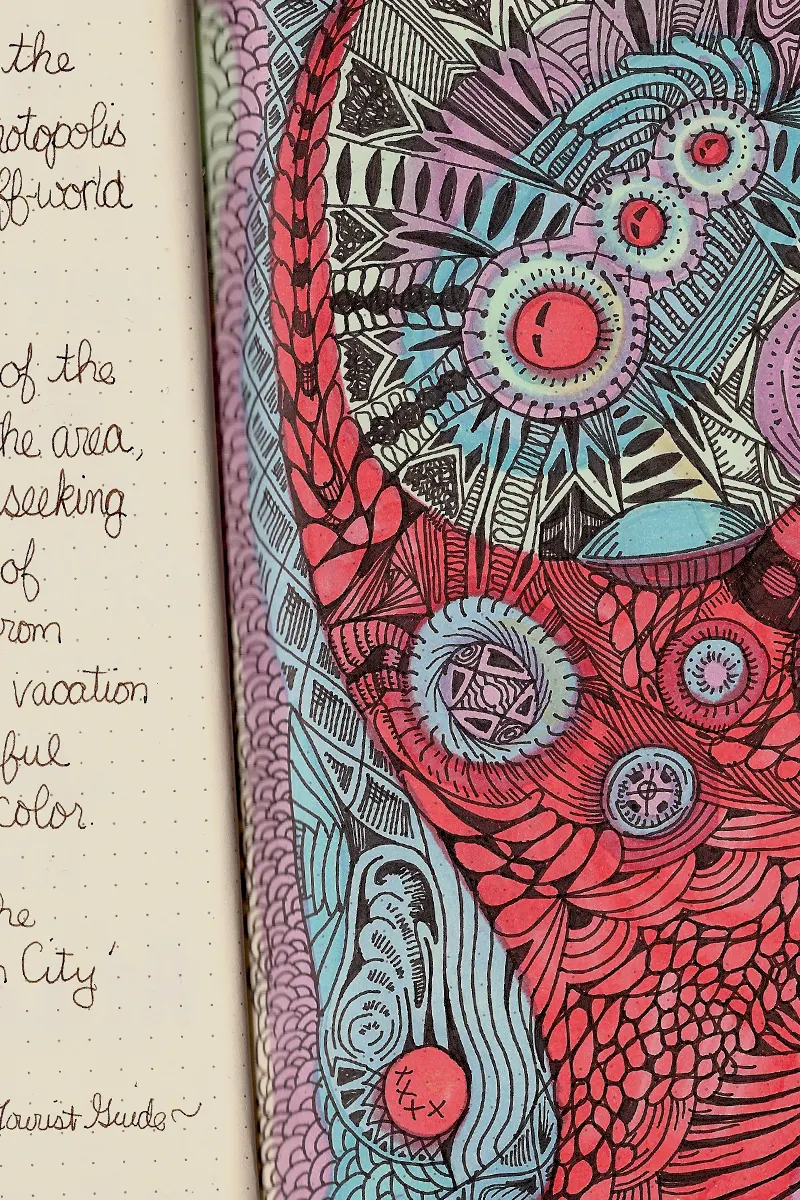 an opened sketchbook with creative illustrations on its pages