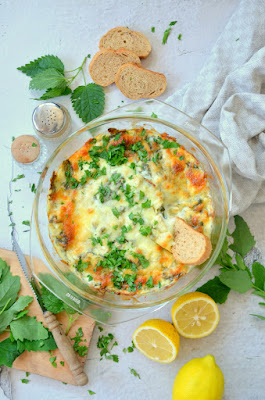 Der Melde-Artischocken-Dip frisch aus dem Ofen. Die Ränder sind appetitlich gebräunt und der Dip ist mit frischer Petersilie bestreut.