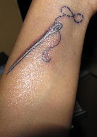 infinity symbol sewing needle tattoo