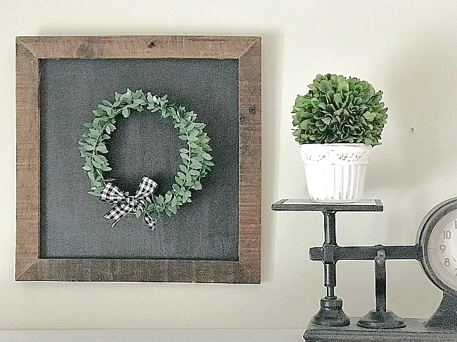 chalkboard with a wreath and a scale