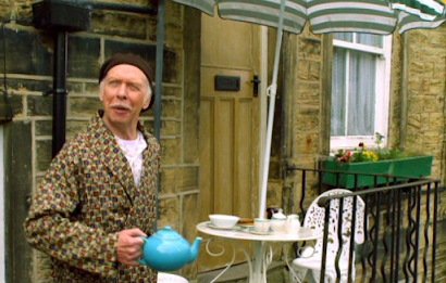 Old bloke with tea pot and breakfast table