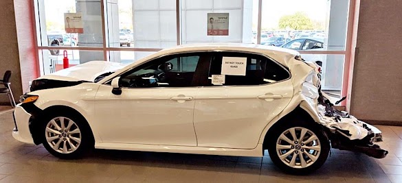 Showing The Customers Only How Good Engineered Your Cars Are, Ought To Live On A Affair Of Pride For Machine Companies. But Few Accept A Crashed Machine Inwards The Showroom... Toyota Is Rightfully Proud To Demo Their Customers How Good A Camry Holds Upwards When Sandwiched Betwixt Semis