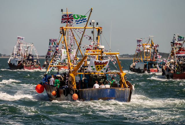 Photo of some of the colourful boats taking part in Maryport Trawler Race on Saturday