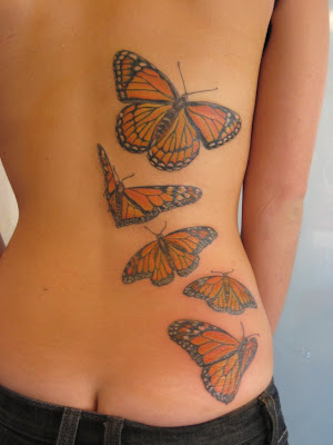 five monarch butterflies at lower back tattoo Five Monarch Butterflies 