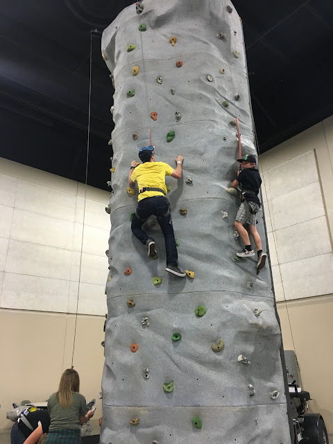 Ben climbing a rock wall