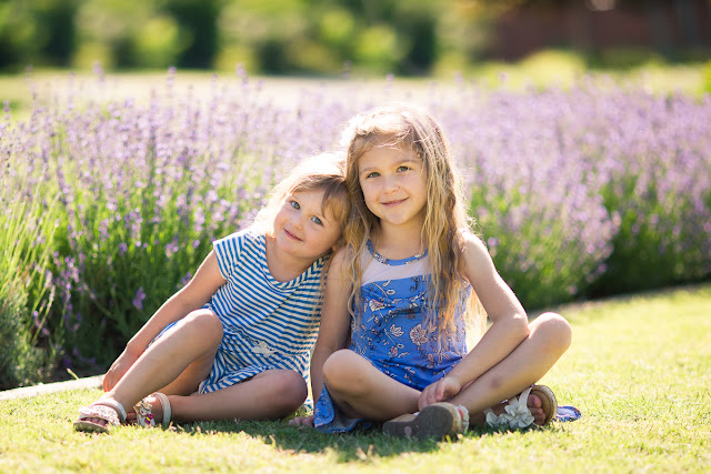  Often, our family pictures consist of posed photos from holidays and special occasions.   But as a lifestyle photographer, it is my desire to capture a visual documentation of  childhood in-the-making.  I never know what the results will be going into a session with children, as my process is kind of a wait-and-see-who-they-are-and-what-they-like-to-do kind of approach.  And as a result, I'm usually able to get a couple of nice shots with the children looking at the camera with authentic smiles.  But mostly what I capture is a whole bunch more showing their unique expressions and glimmers of who they are on the inside.               On this warm, spring day Kala brought her two delightful and energetic daughters, ages 5 and 3, to Will Rogers Park for a photo shoot.  As soon as they emerged from their vehicle in pretty summer dresses, I noticed how the girls had adorned themselves with plastic rings, bracelets and necklaces to make their outfits complete!  Kala also brought a change of clothes...each of their favorite dresses.  She said they would wear them every day if they could!  This would be the perfect outfit for capturing them at this age!   And made me laugh as I remembered my own favorite item of clothing at that age...my beloved Fonzie (from Happy Days) shirt with his two thumbs sticking up saying, "Ayyy!"            As we walked along the rambling paths through the park, the girls ahead of us scampering over rocks and bridges, Kala said both girls were like night-and-day.  One loves to have her picture taken, while the other is a complete tomboy.  Can you guess which is which?            "Sisters are for life.  She is the only person in the world who shares my memories of our childhood, our parents, our struggles, our sorrows, and yes, even our moments of happiness and triumph.  My sister is the one person who truly knows me, as I know her."   --Lisa See, Shanghai Girls           If you would like to capture some of these same "real life" moments in your family, please visit my Family page at MichelleValantinePhotography.com.  