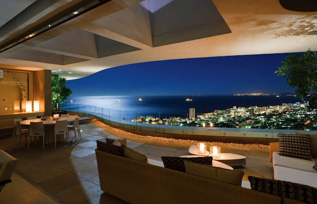 Picture of the city and the ocean as seen at night from the mansion