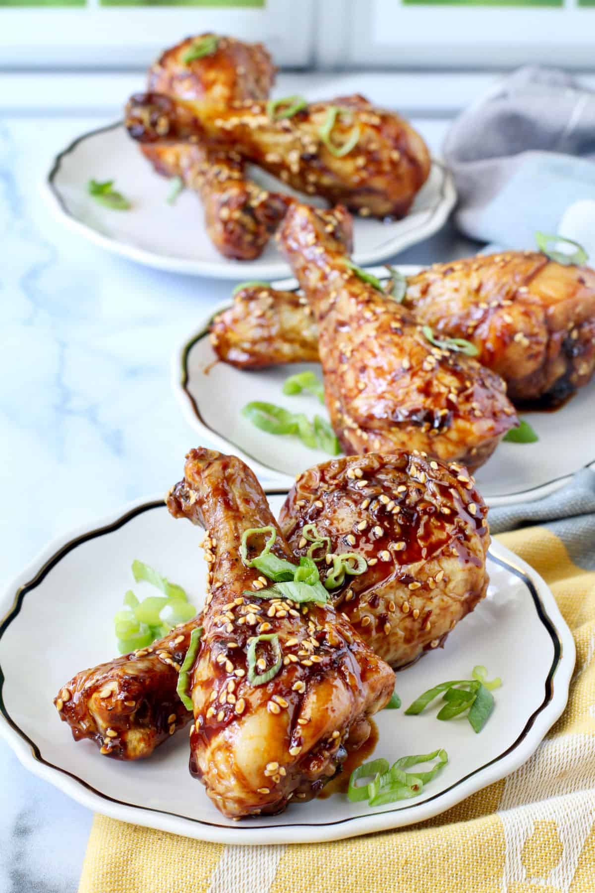 Apple Soy Glazed Chicken Legs on small plates.