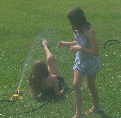 playing in the sprinkler