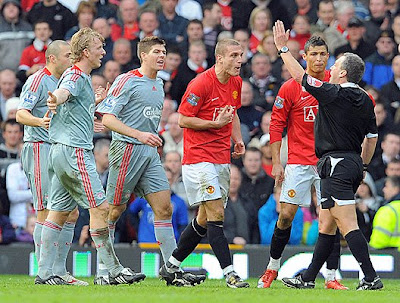 Manchester United's Portugese midfielder Cristiano Ronaldo (second right) appeals to referee Alan Wiley (right) after Serbian defender Nemanja Vidic (third right) is sent off against Liverpool.
