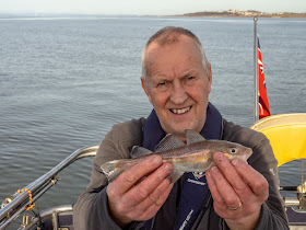 Photo of Phil with the codling that was returned to the water