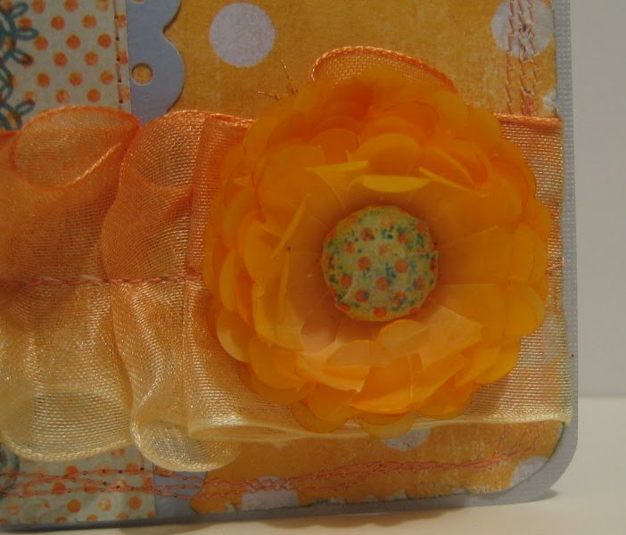 The flower is made by punching scallops from a sheet of apricot coloured 