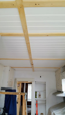 Beadboard installed on kitchen ceiling with lath to cover the seams