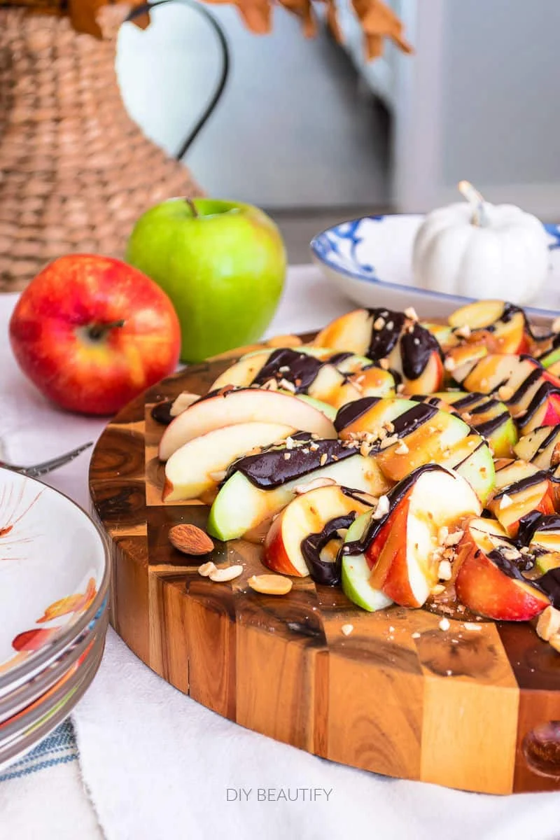 apple nachos with caramel and chocolate drizzle and crushed nuts