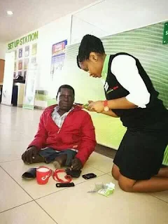 A lady assisting a physical challenged person in Nakuru.