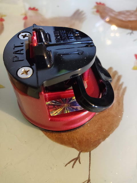 red AnySharp Pro knife sharpener fixed to worktop with suction cup