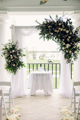 lake nona country club balcony wedding arch with flowers