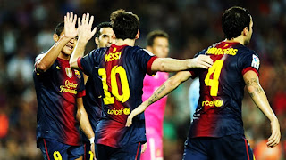 Lionel Messi celebrating with team members of barcelona