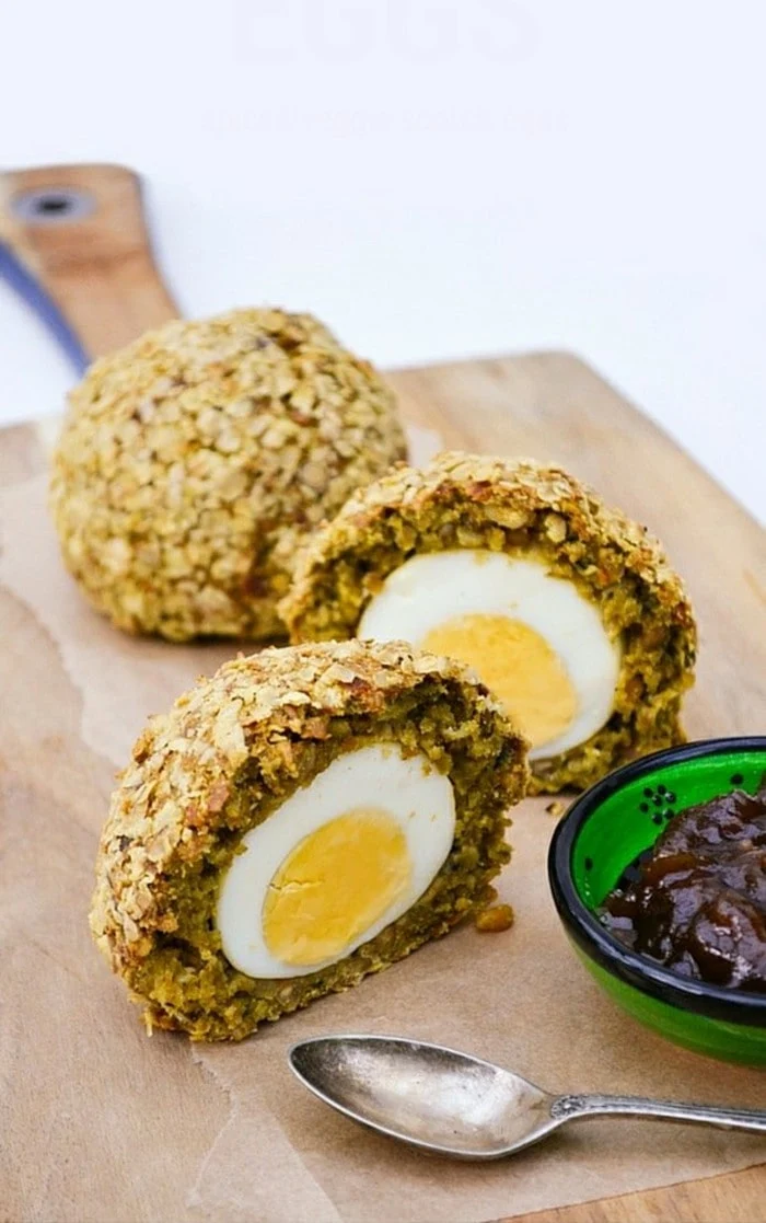 Vegetarian Scotch Eggs cut in half and served with chutney